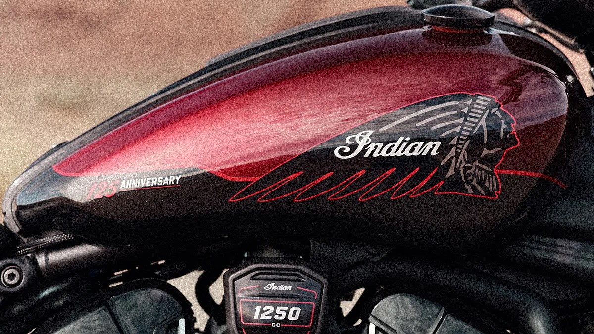 Glossy red and black Indian motorcycle fuel tank with "125 Anniversary" and Native American head logo.