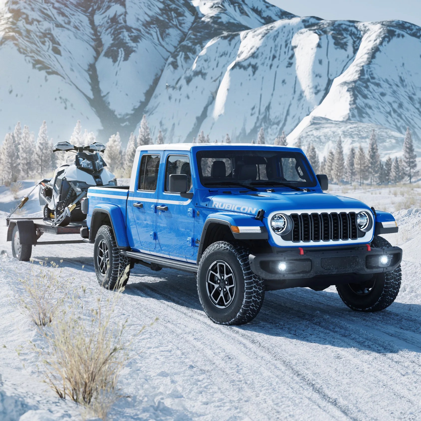 Blue Jeep Gladiator Rubicon pickup truck towing a snowmobile on a trailer in a snowy mountainous landscape.