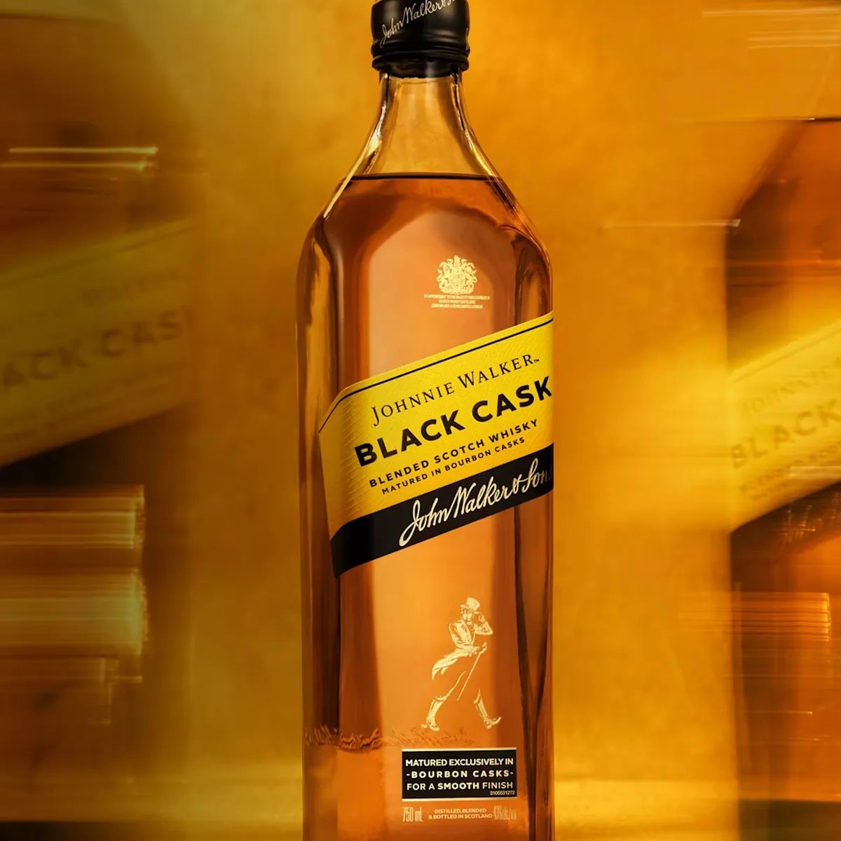 Bottle of Johnnie Walker Black Cask blended Scotch whisky with yellow and black label on a golden background.