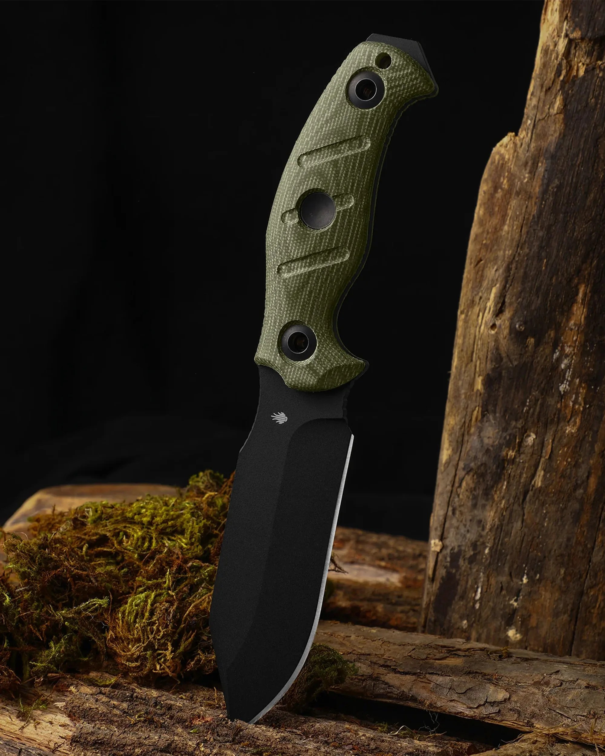 Tactical fixed-blade knife with black blade and textured olive green handle standing on mossy wood.