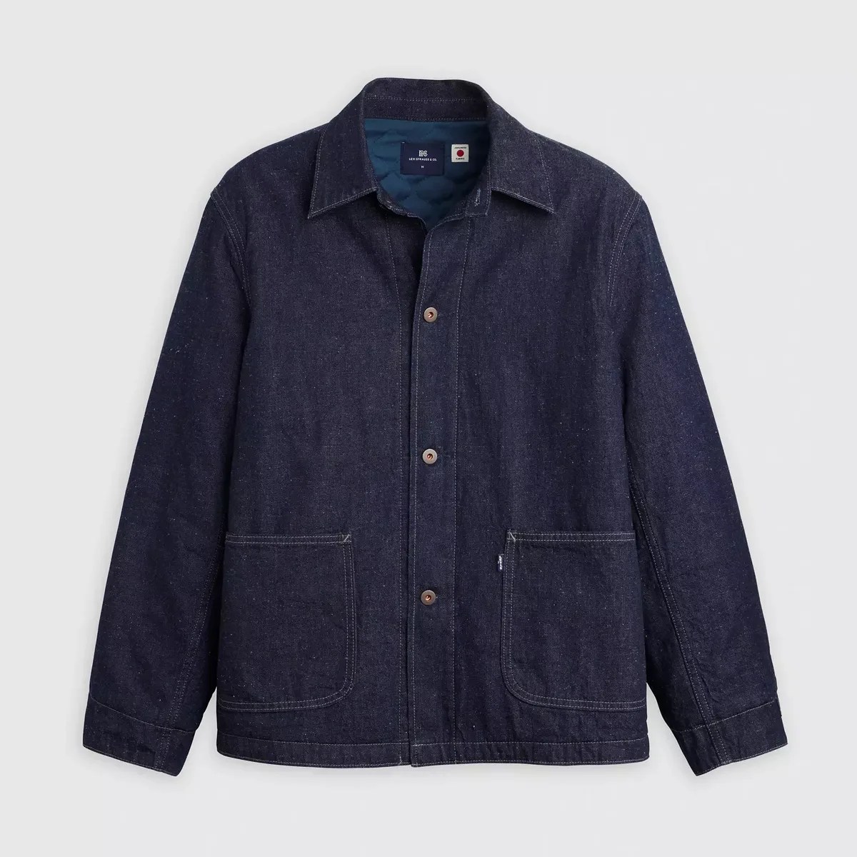 Dark indigo denim chore jacket with front buttons and two large patch pockets.