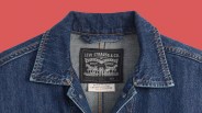 Dark blue denim jacket collar with Levi Strauss & Co. label and Levi's Premium tag on a red background.
