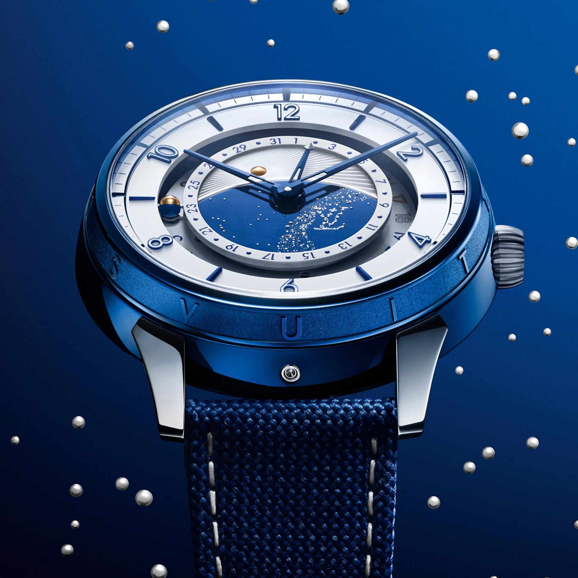 Blue and silver luxury wristwatch with a textured blue strap and celestial dial design.