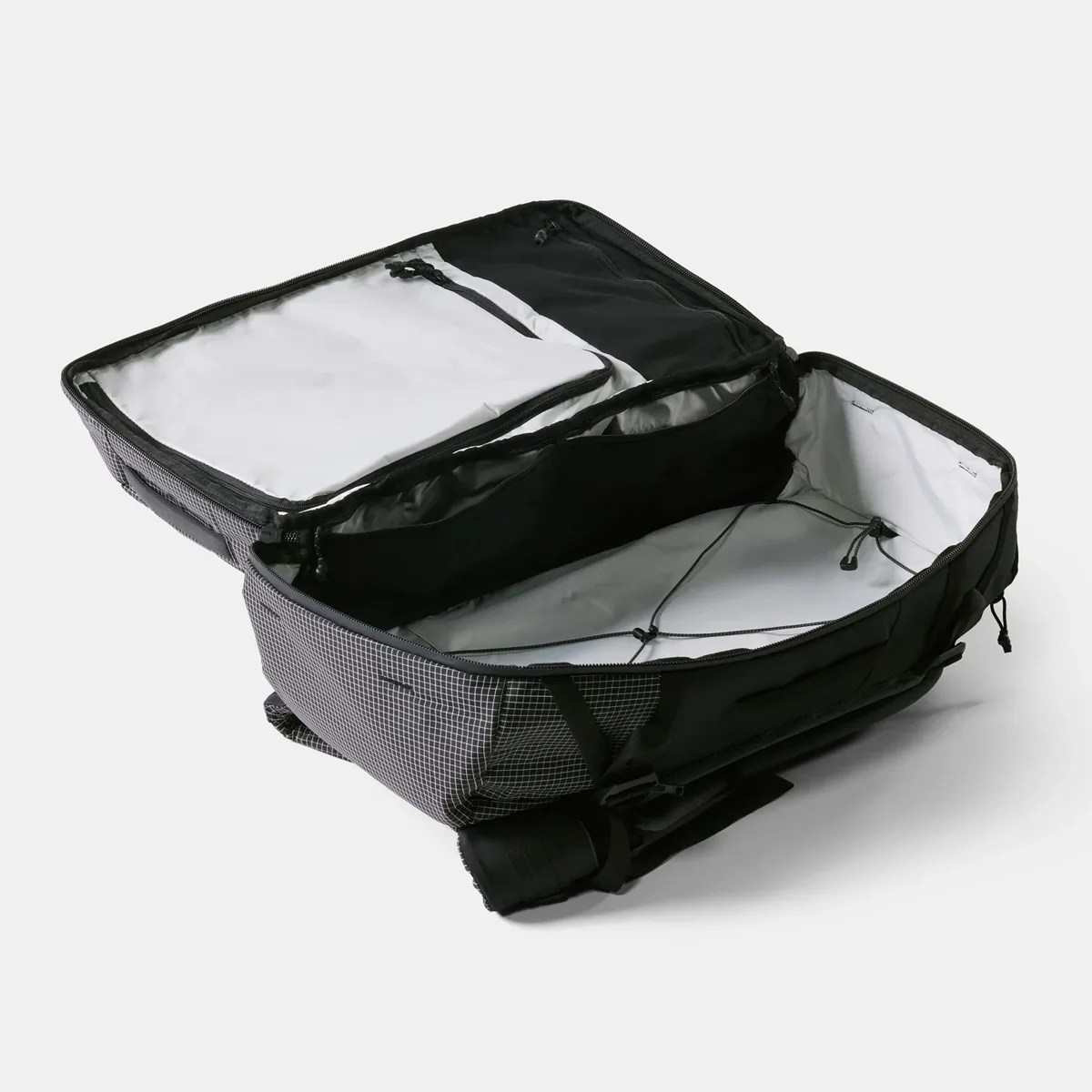 Open black and gray checkered travel backpack with multiple zippered compartments and adjustable straps inside.