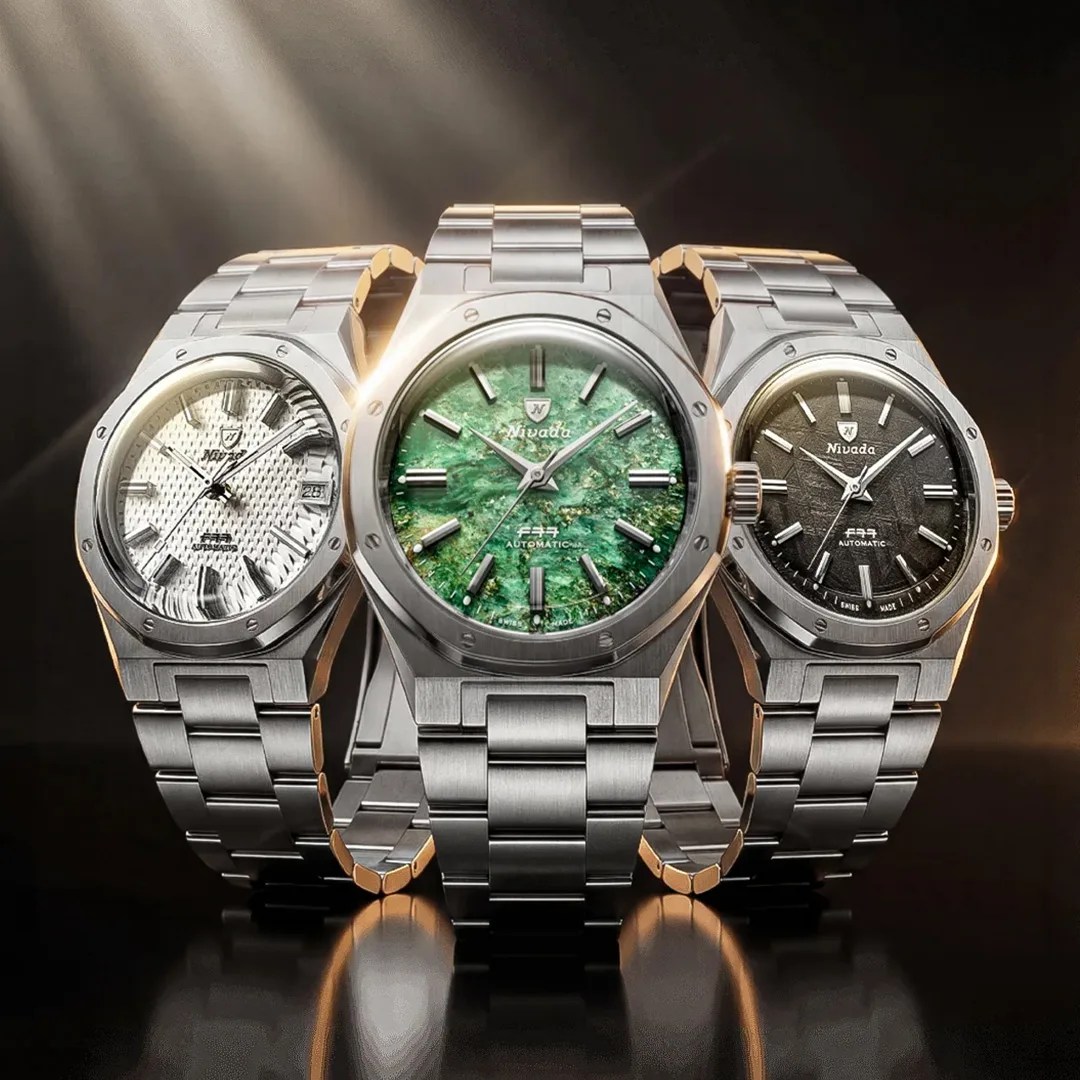 Three stainless steel wristwatches with textured dials in white, green, and black, displayed with light beams.