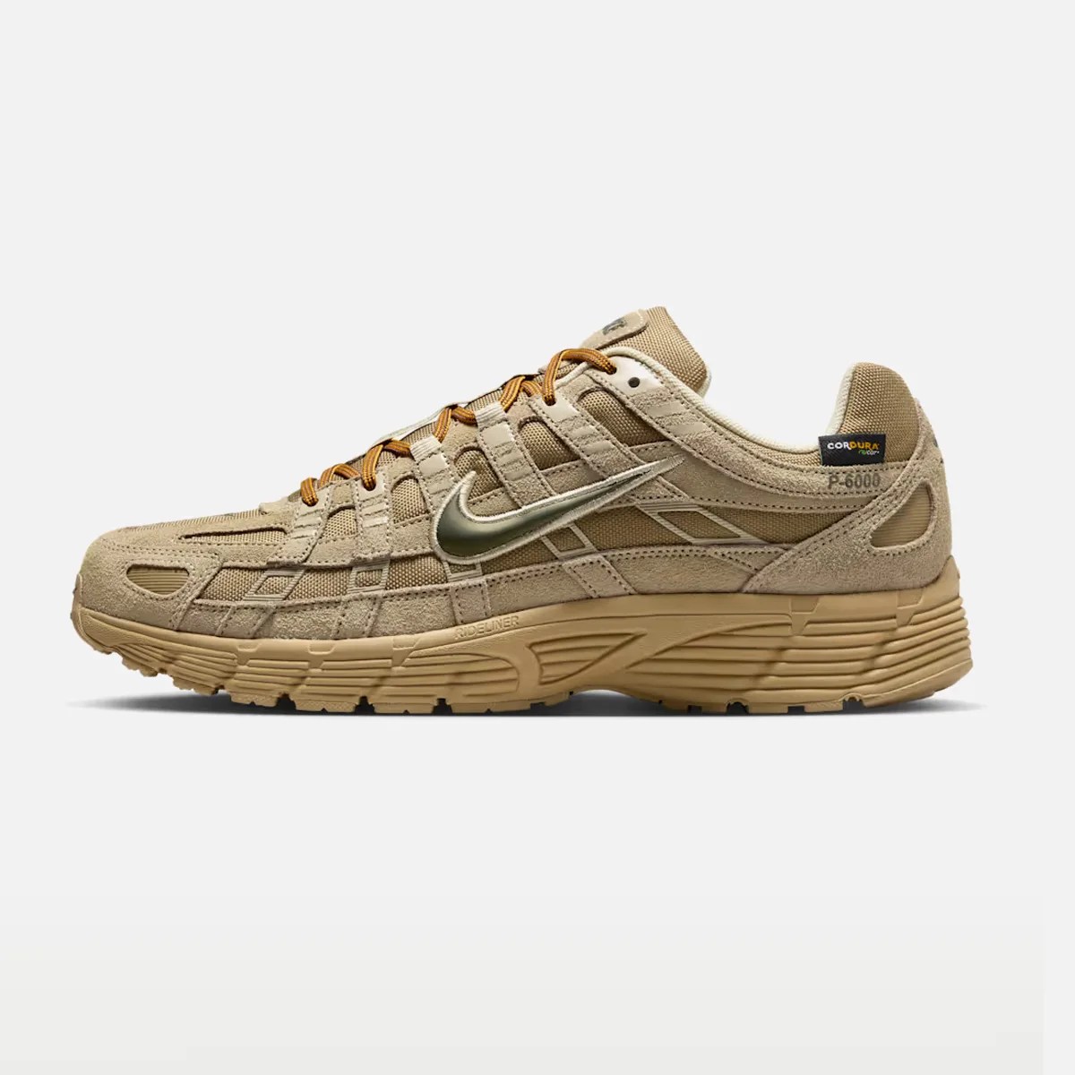 Tan Nike sneaker with mesh and suede upper, metallic swoosh, and thick rubber sole.
