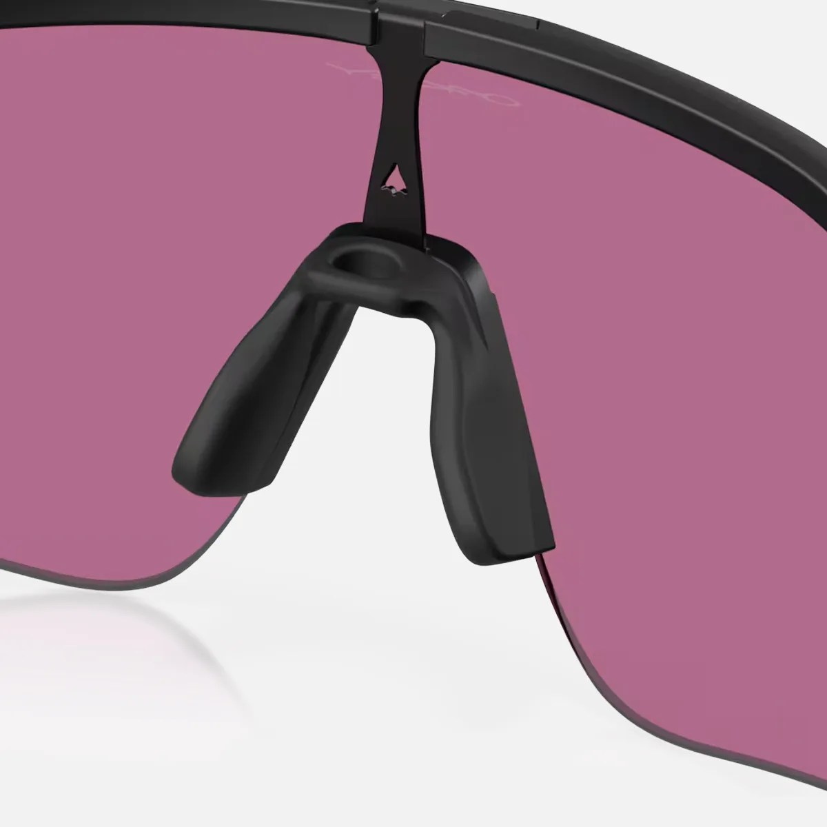 Close-up of black nose pads on sunglasses with purple-tinted lenses and a black frame.