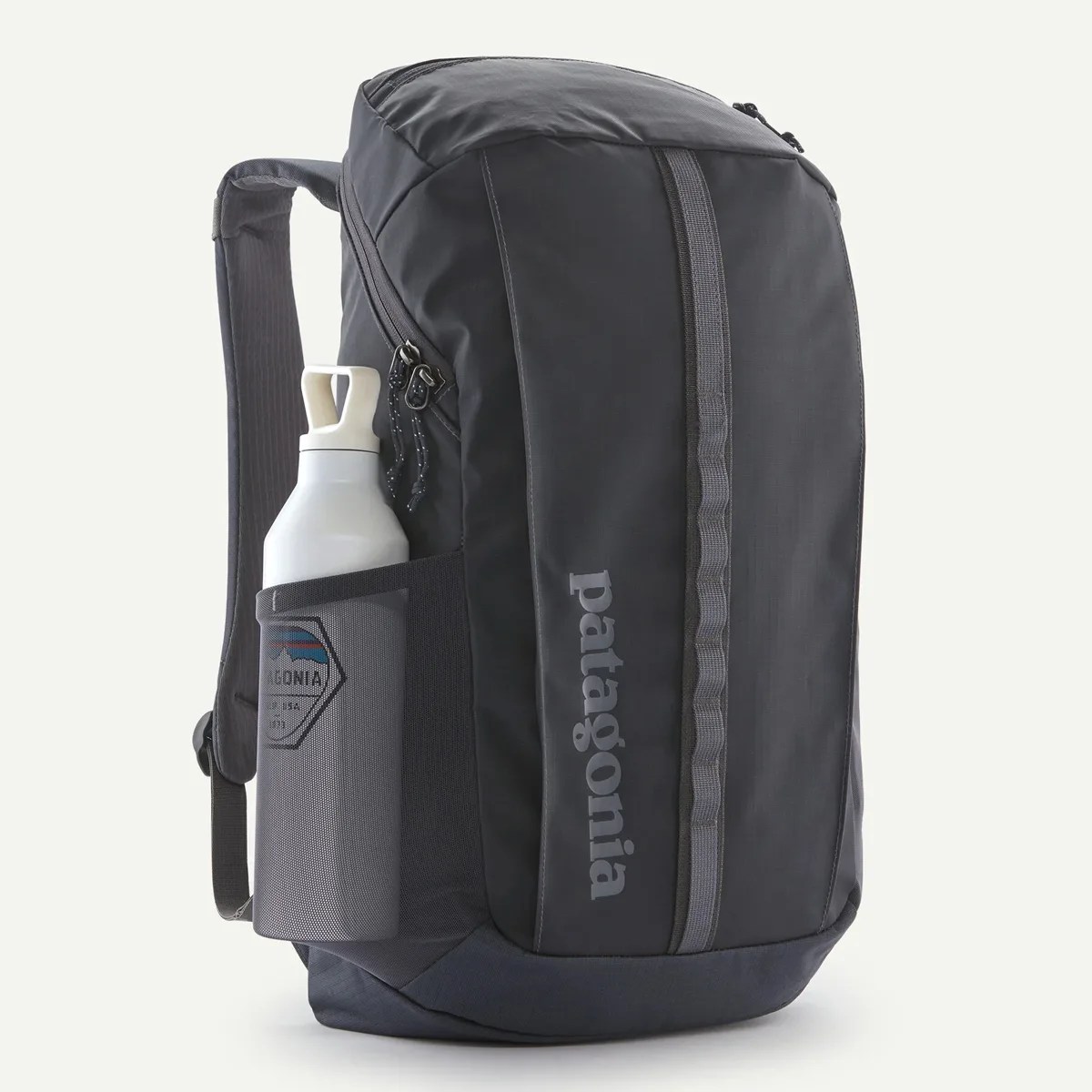 Black Patagonia backpack with side mesh pocket holding a white water bottle.