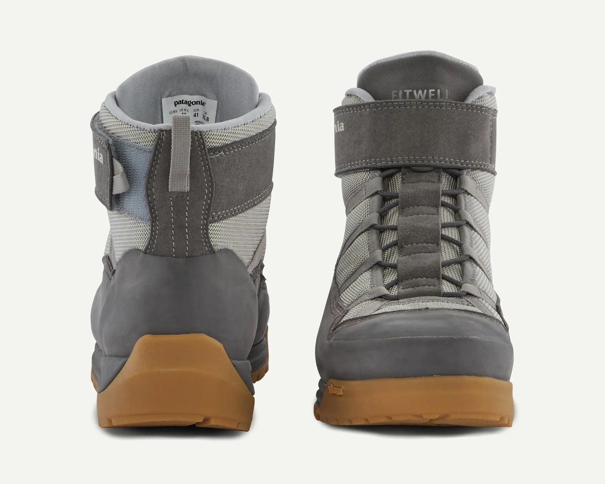 Pair of gray Patagonia hiking boots with gum rubber soles shown from back and front.