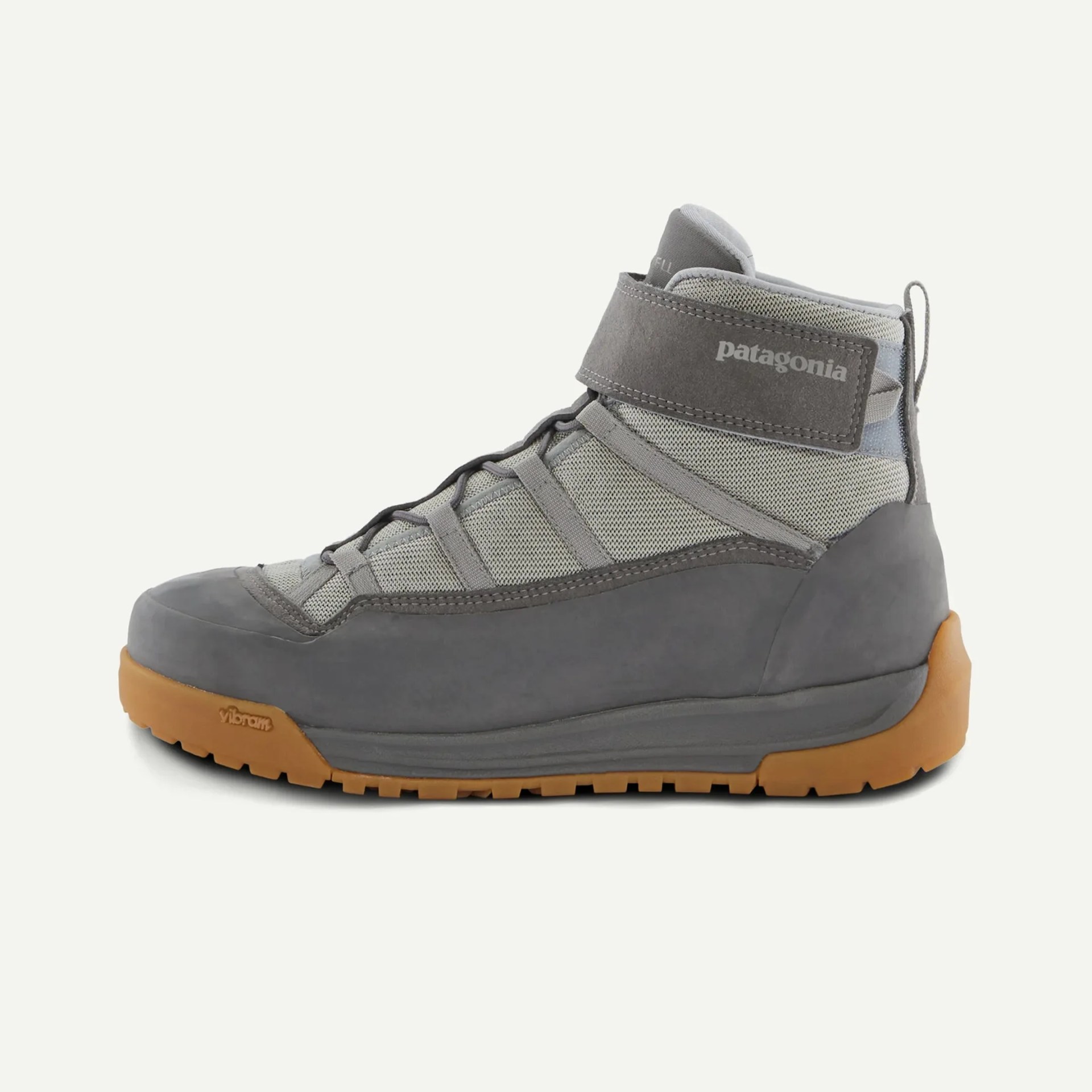 Gray high-top Patagonia hiking shoe with mesh upper, suede overlays, Velcro strap, and gum rubber sole.