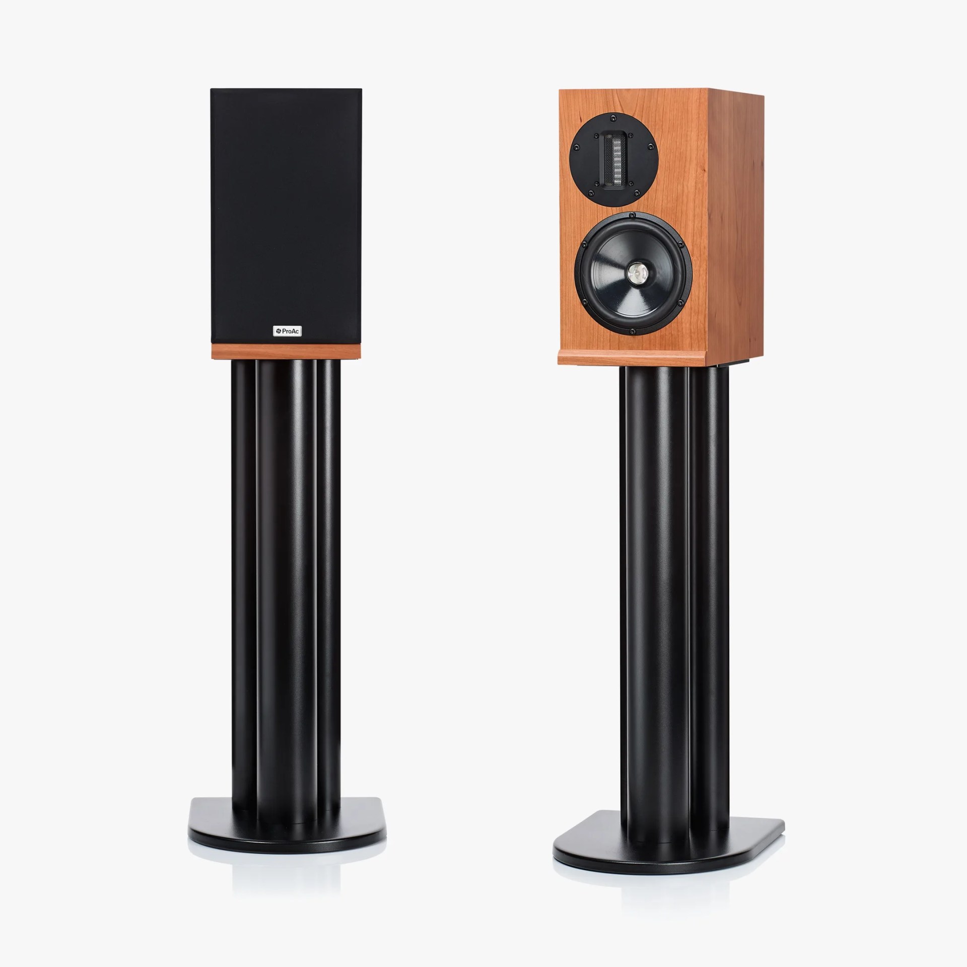 Pair of wooden bookshelf speakers on black cylindrical stands, one with grille on and one without.