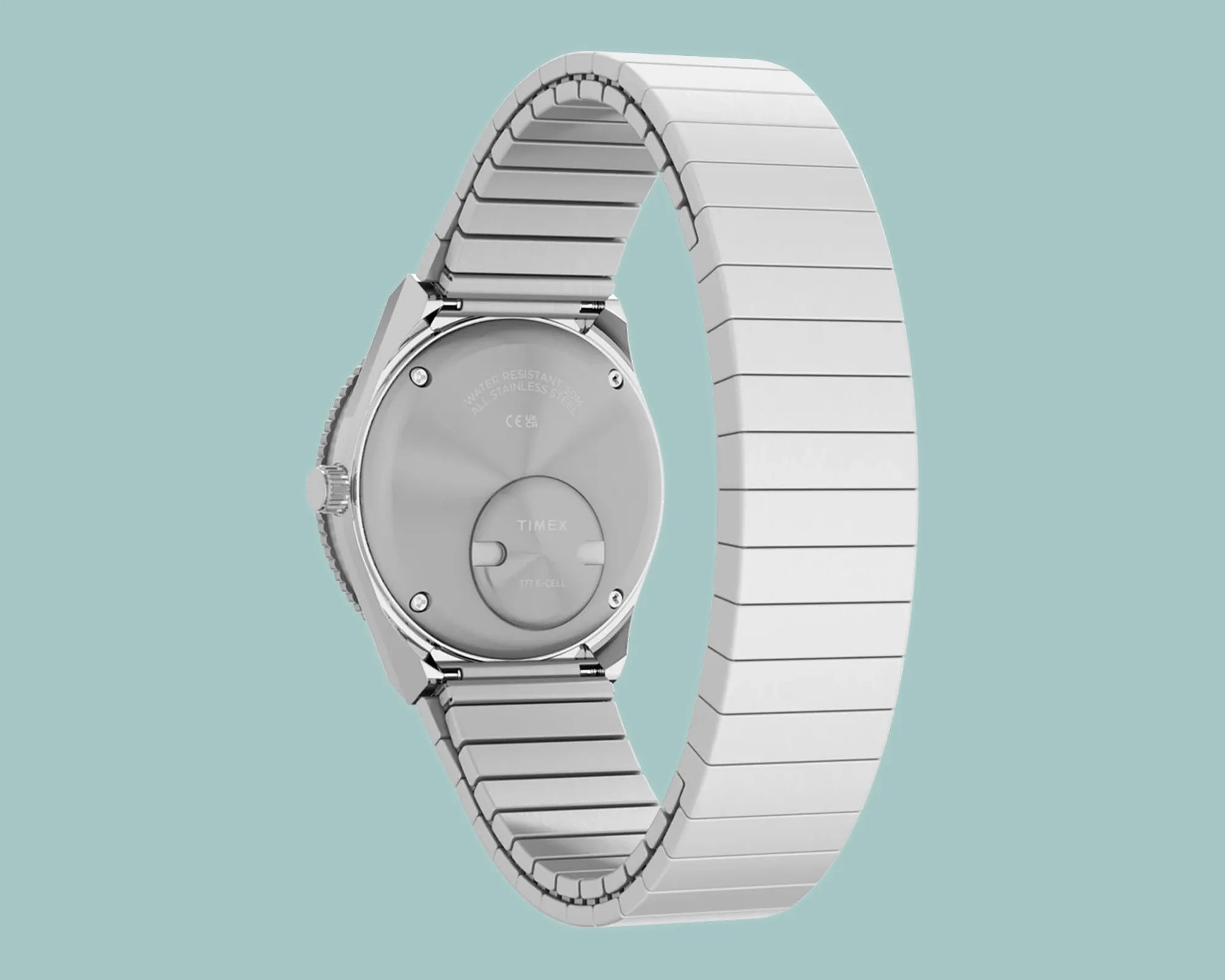 Back view of a silver stainless steel Timex wristwatch with a linked metal band on a light blue background.