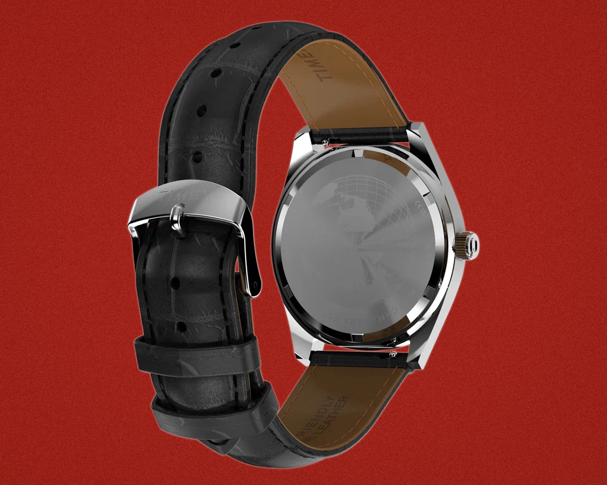 Back view of a silver Timex watch with a black leather strap and brown inner lining on a red background.