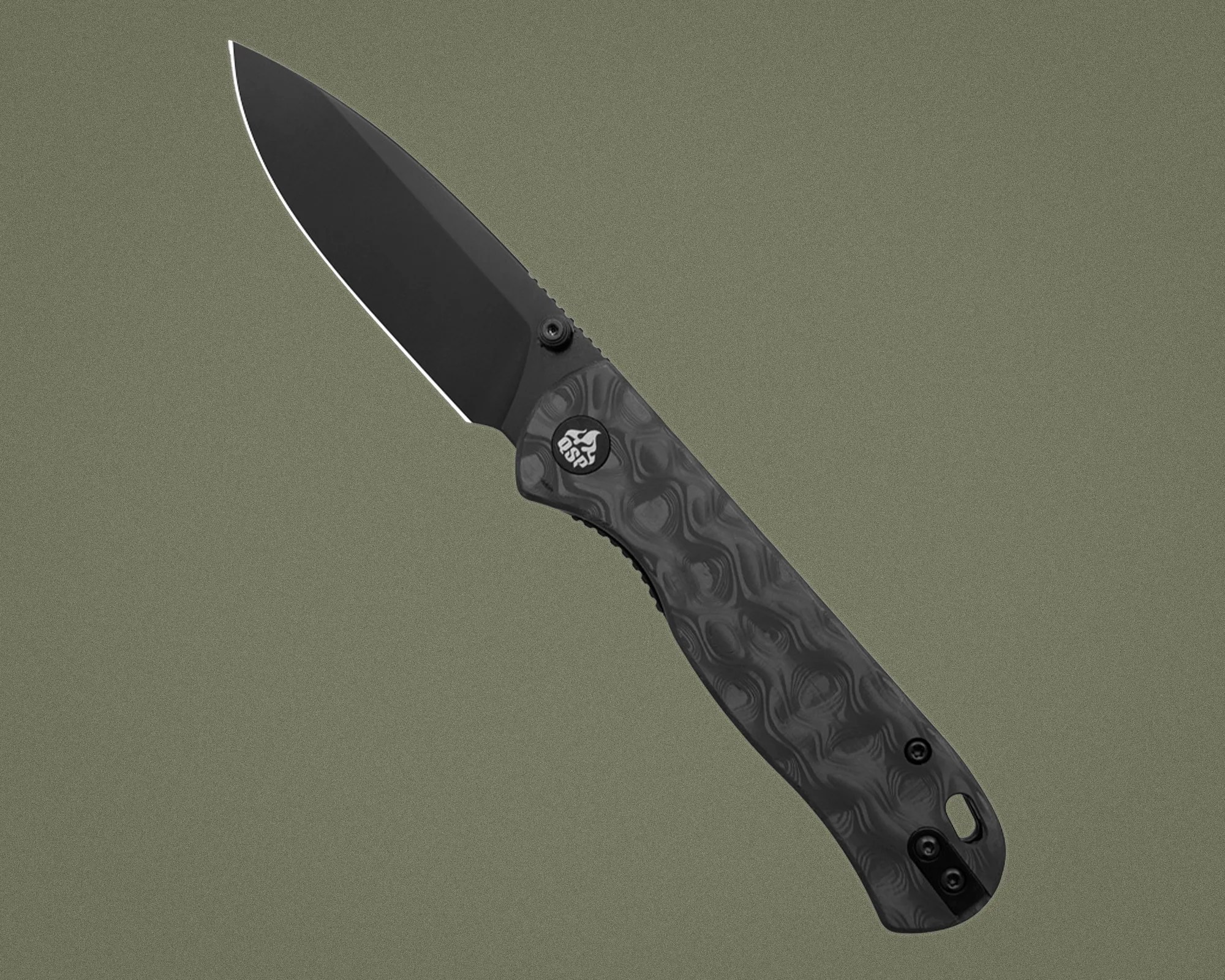 Black folding knife with textured dark gray handle and partially serrated blade on olive background.
