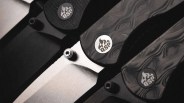 Close-up of three folding knives with patterned dark handles and QSP logos near the blade pivots.