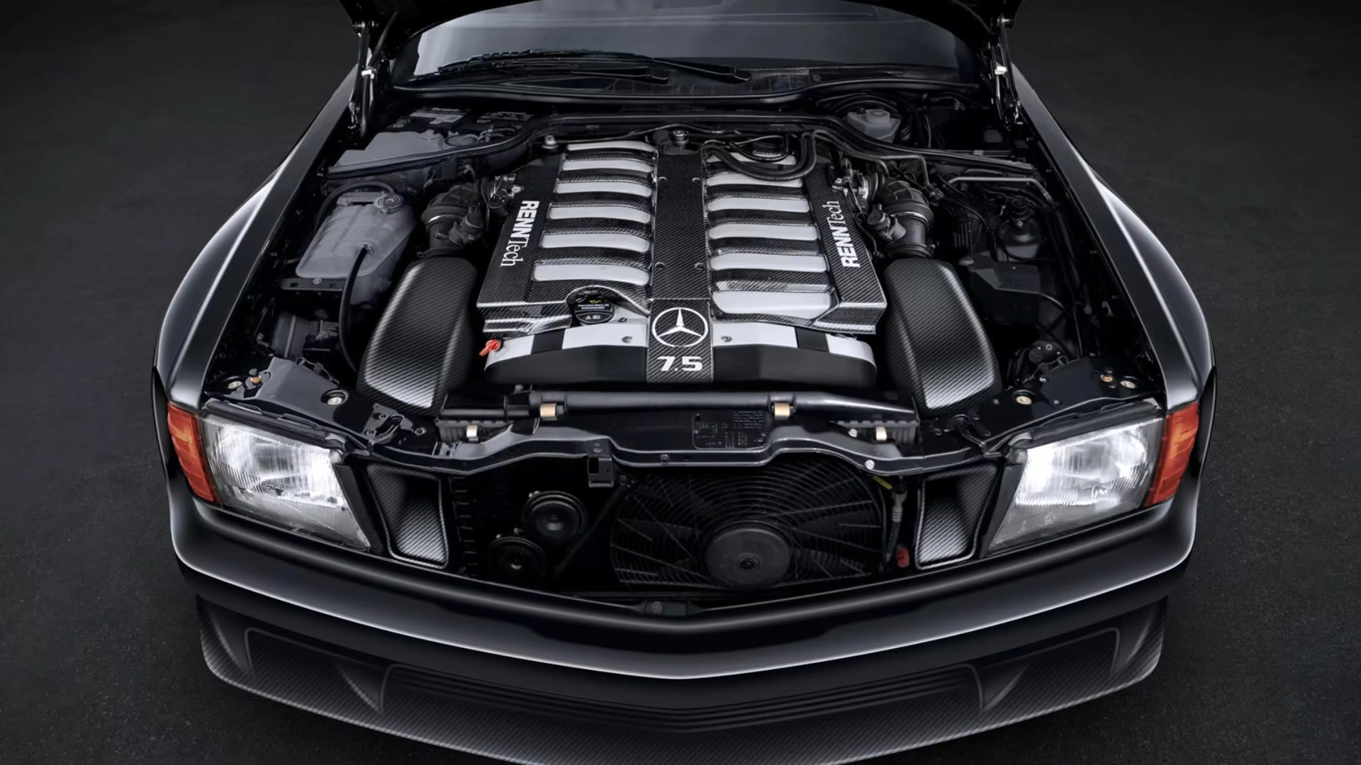 Mercedes-Benz engine bay with a carbon fiber RENNTech 7.5 engine cover and visible front headlights.