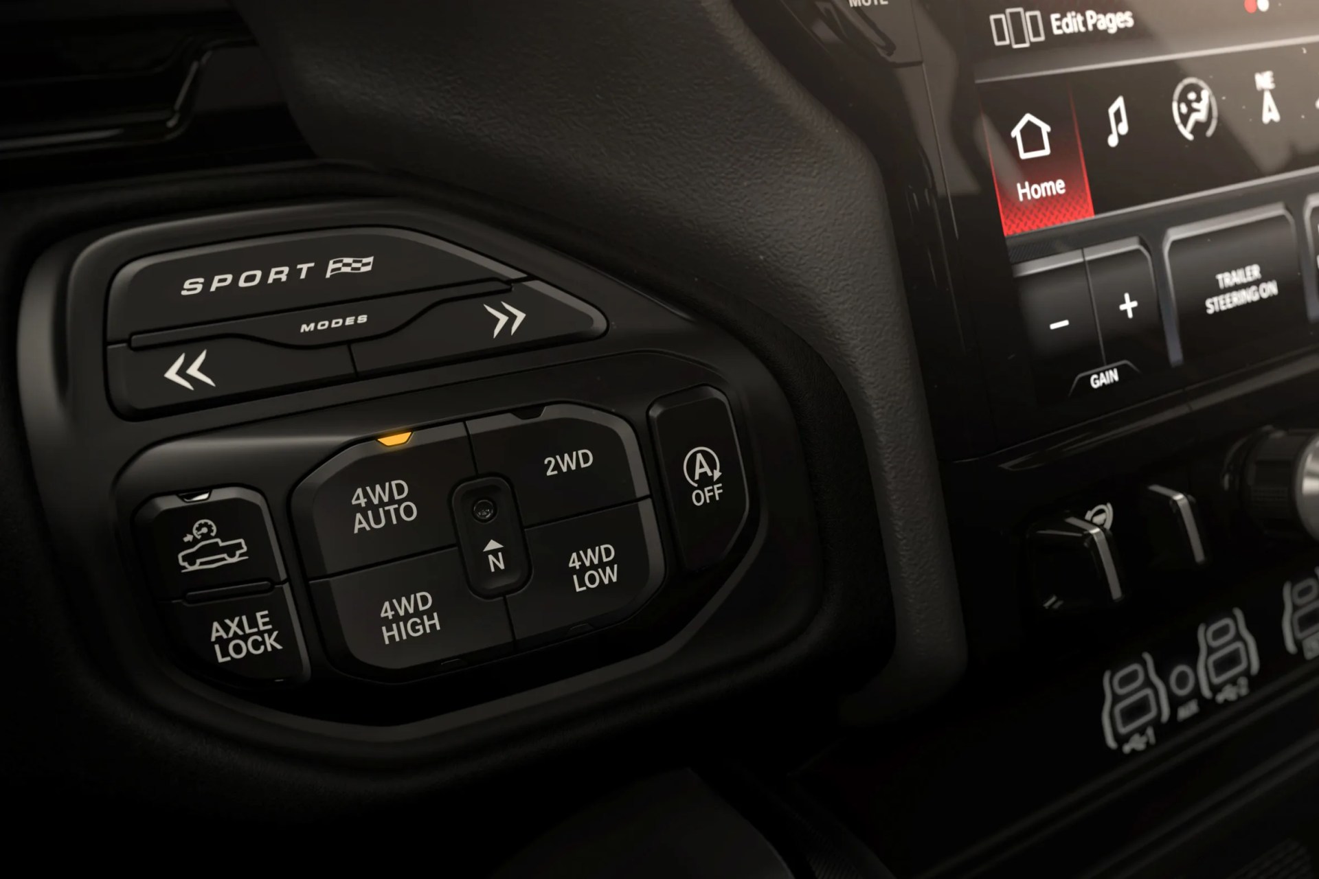 Close-up of a black vehicle control panel with 4WD mode buttons, axle lock, and sport mode switch.