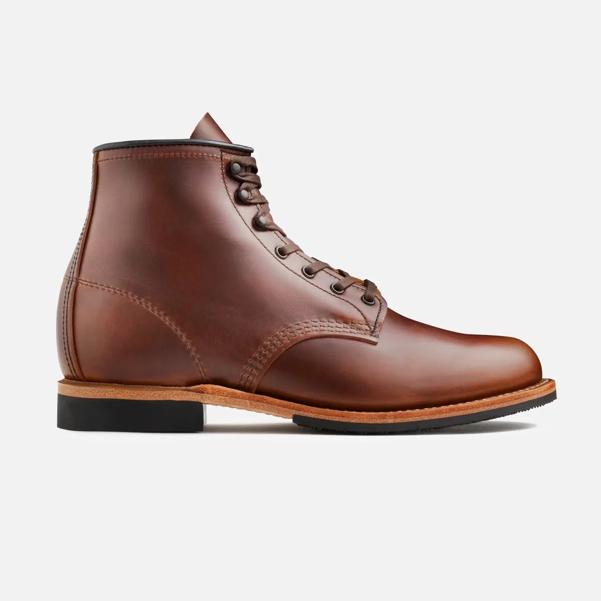 Brown leather lace-up ankle boot with black sole and light brown welt.