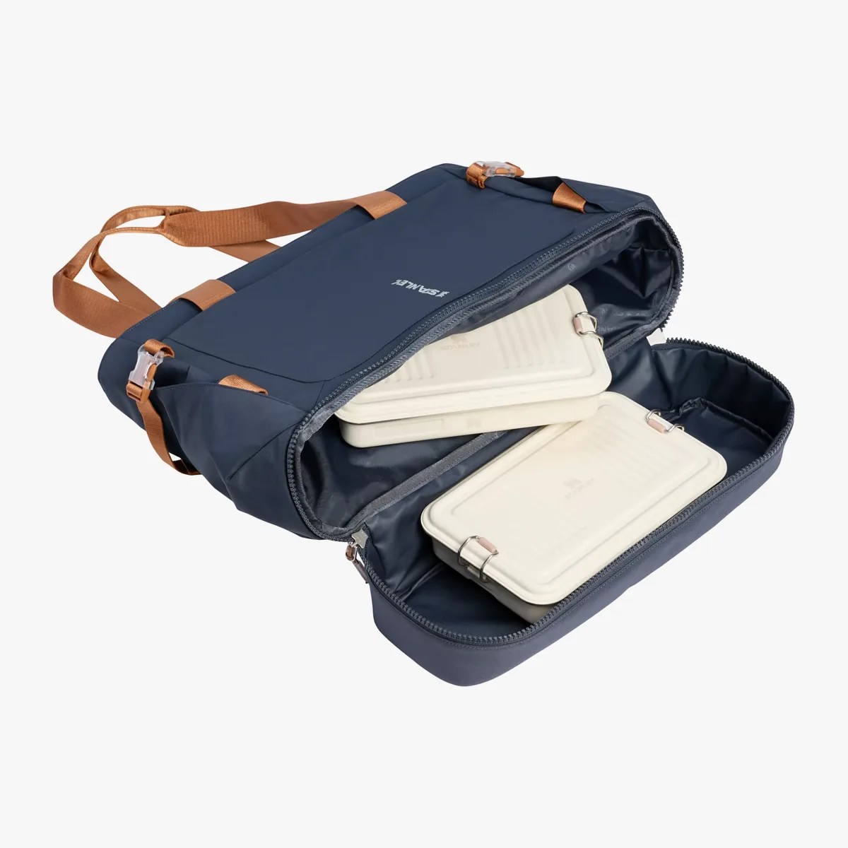 Navy blue insulated lunch bag with brown handles and two white rectangular food containers inside.