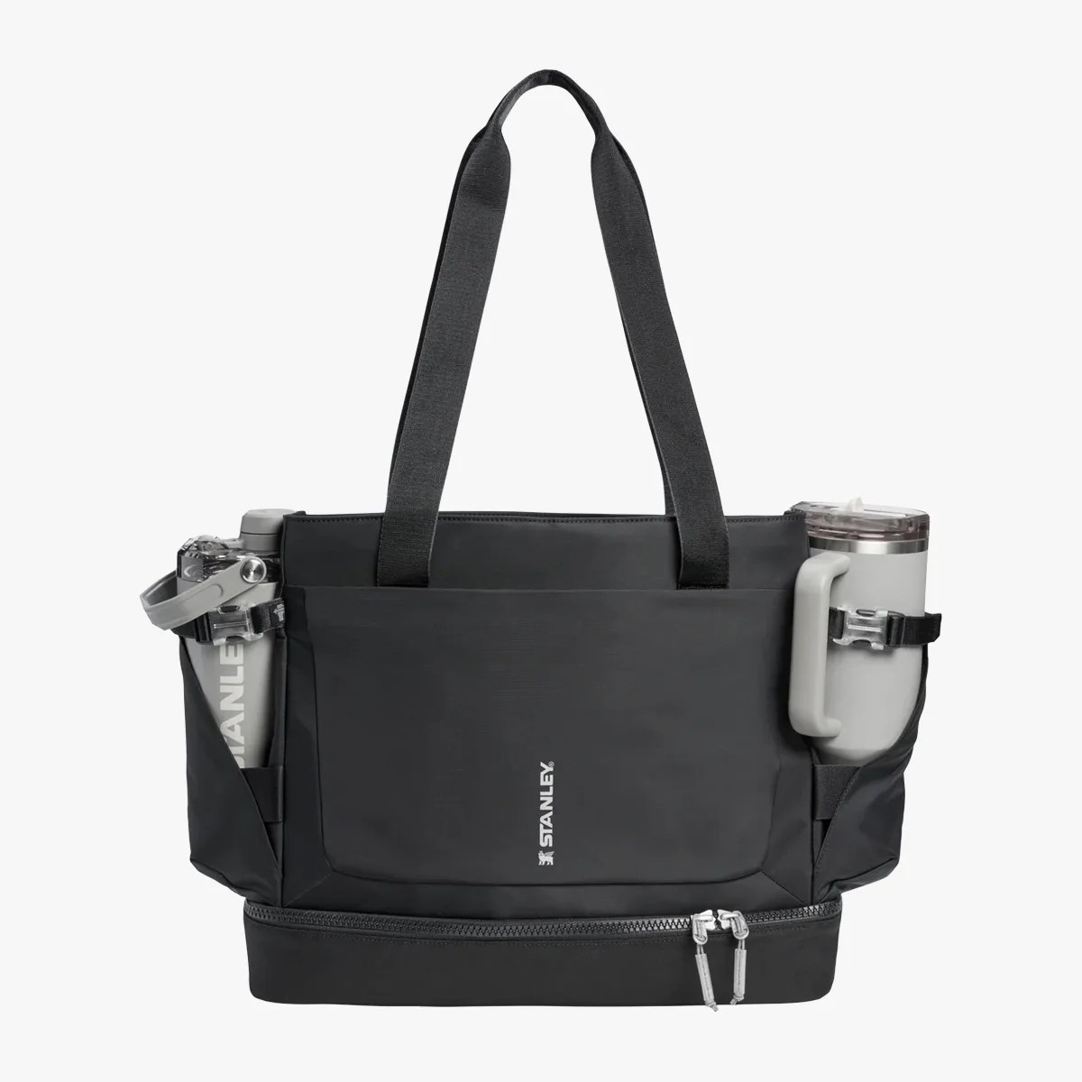 Black Stanley tote bag with two wide handles, front pocket, side holders with gray tumblers, and bottom zipper compartment.
