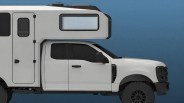 White camper truck with black trim and large off-road tires against a blue background.
