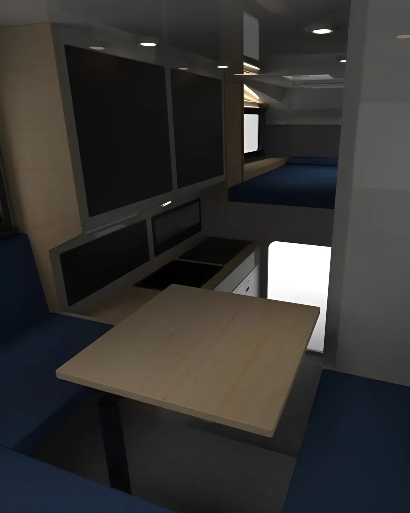 Compact camper interior with light wood table, blue cushioned seating, small kitchen area, and elevated sleeping platform.