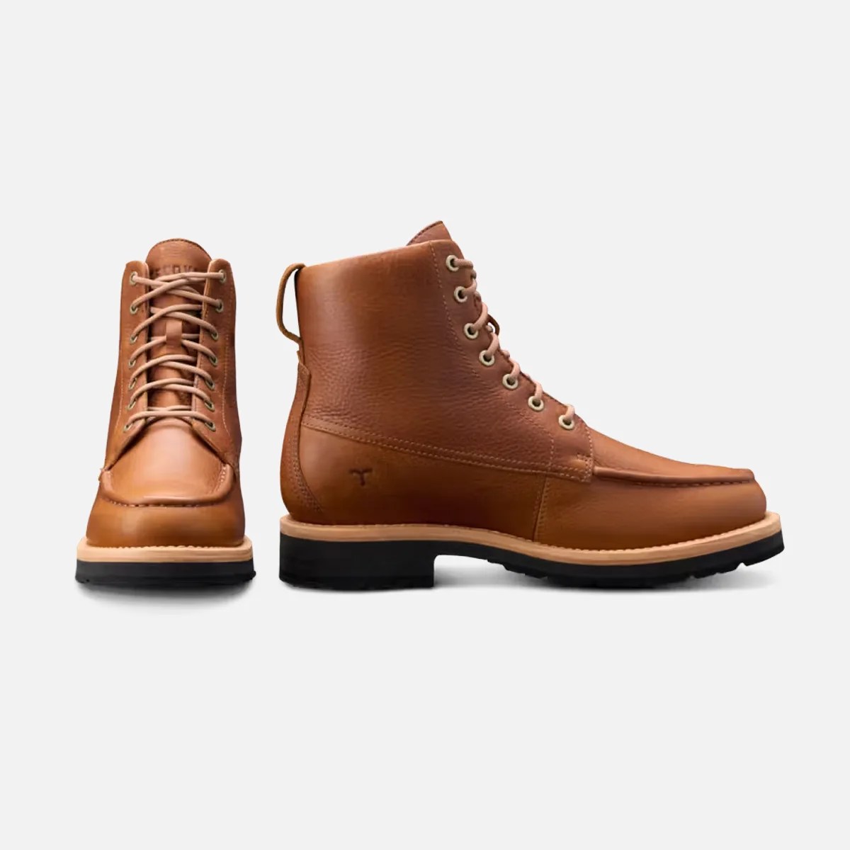 Pair of tan leather lace-up boots with black soles, one shown front-facing and the other side-facing.