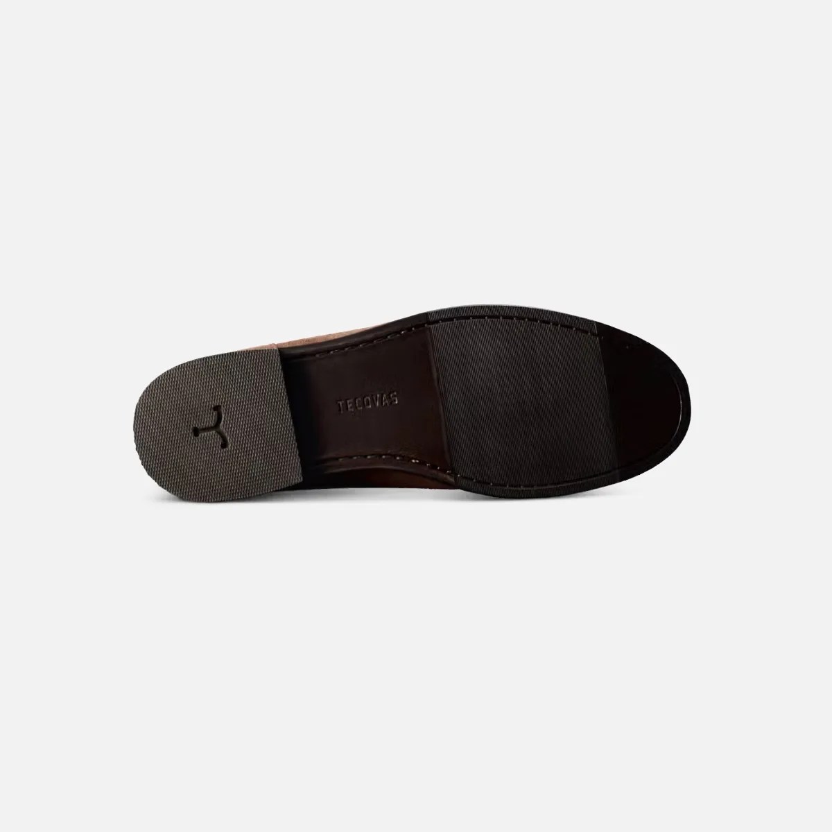 Sole of a brown leather shoe with textured rubber heel and forefoot, embossed with "TECOVAS" logo.