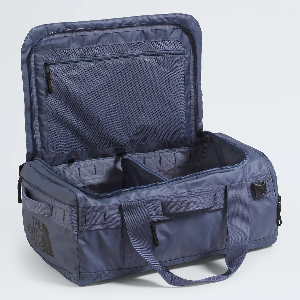 Blue rectangular duffel bag with dual handles, zippered mesh pocket inside lid, and "The North Face" logo on the side.