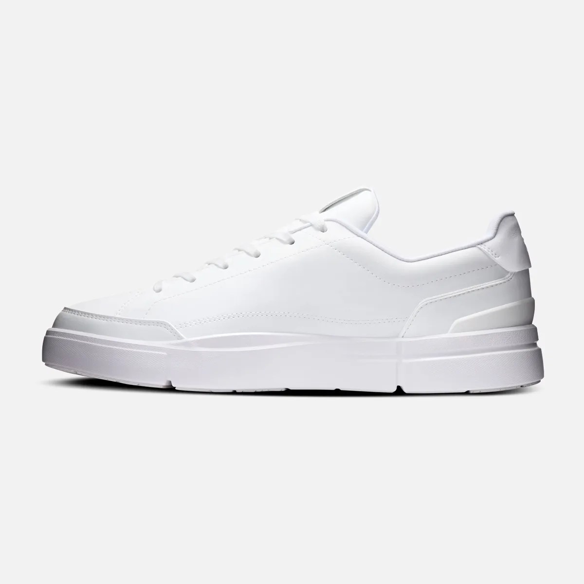 White low-top sneaker with thick sole and lace-up design on a plain background.