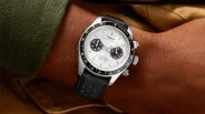 Timex Waterbury chronograph watch with white dial, black subdials, black tachymeter bezel, and black leather strap on wrist.