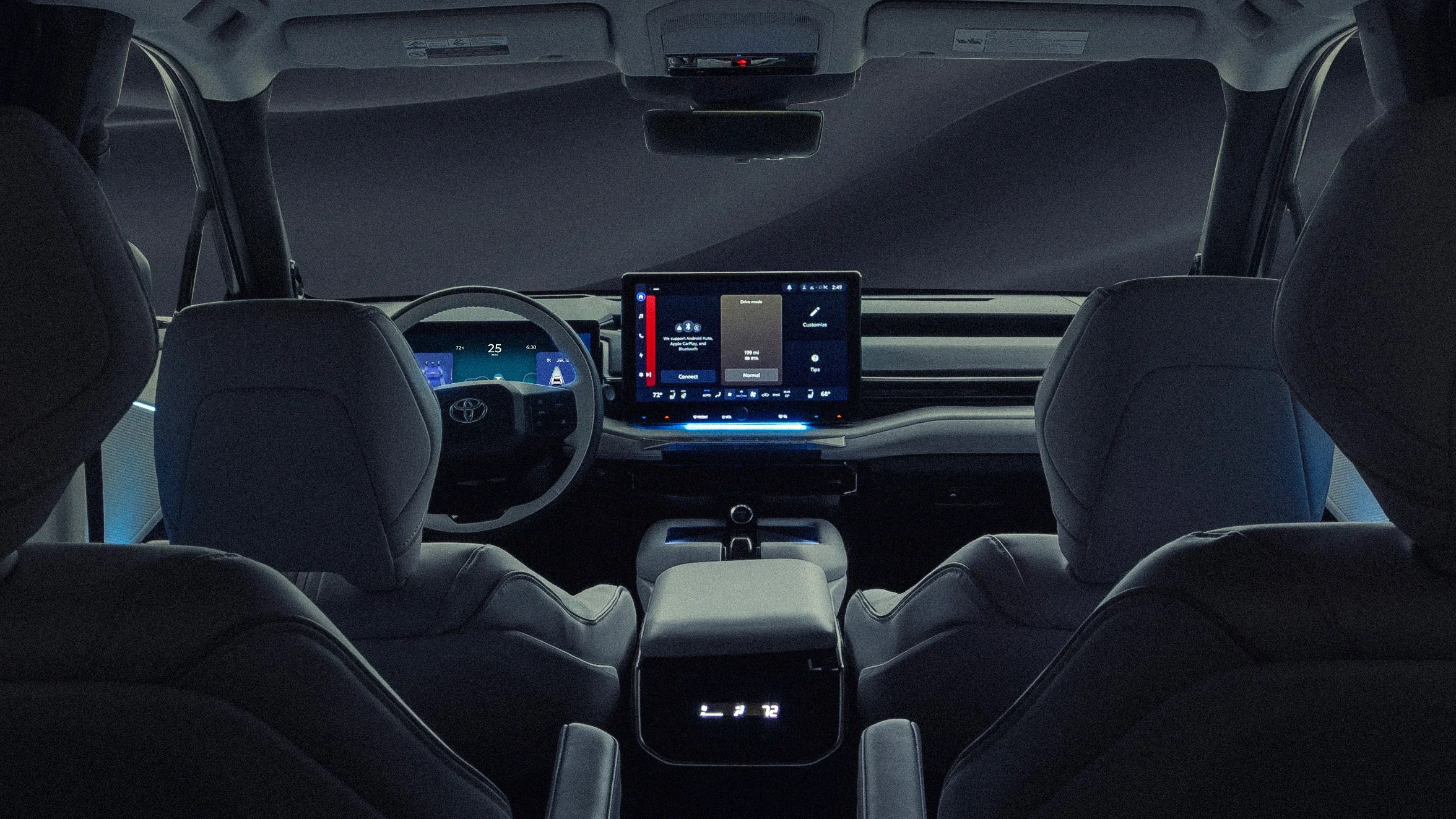 Interior view of a modern car with a digital dashboard, touchscreen center display, and dark gray seats.
