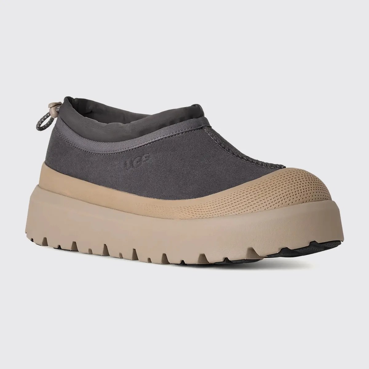 Gray slip-on shoe with beige rubber sole and toe cap, featuring a pull tab at the heel.