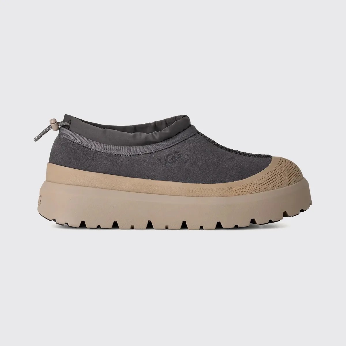 Dark gray slip-on shoe with tan thick rubber sole and toe cap, featuring a drawstring at the heel.