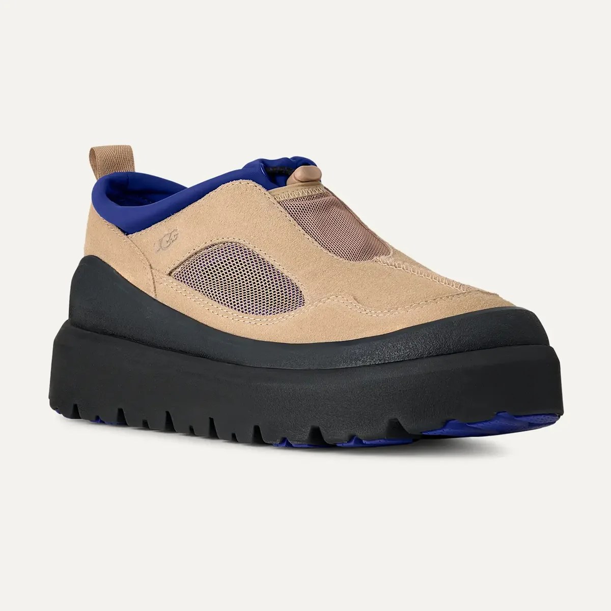Beige suede slip-on shoe with blue mesh accents and thick black platform sole.