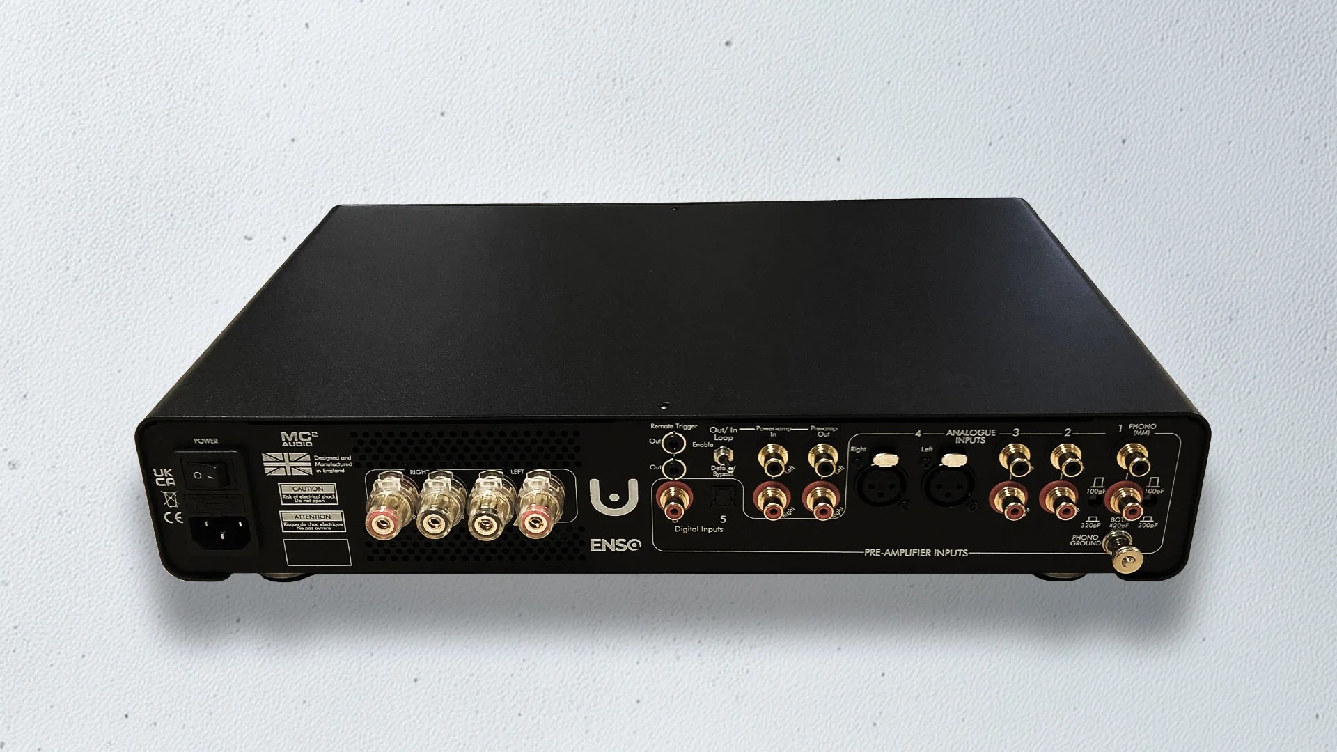 Black MC&sup2; Audio ENSO pre-amplifier with multiple RCA, XLR, and power connectors on a white surface.