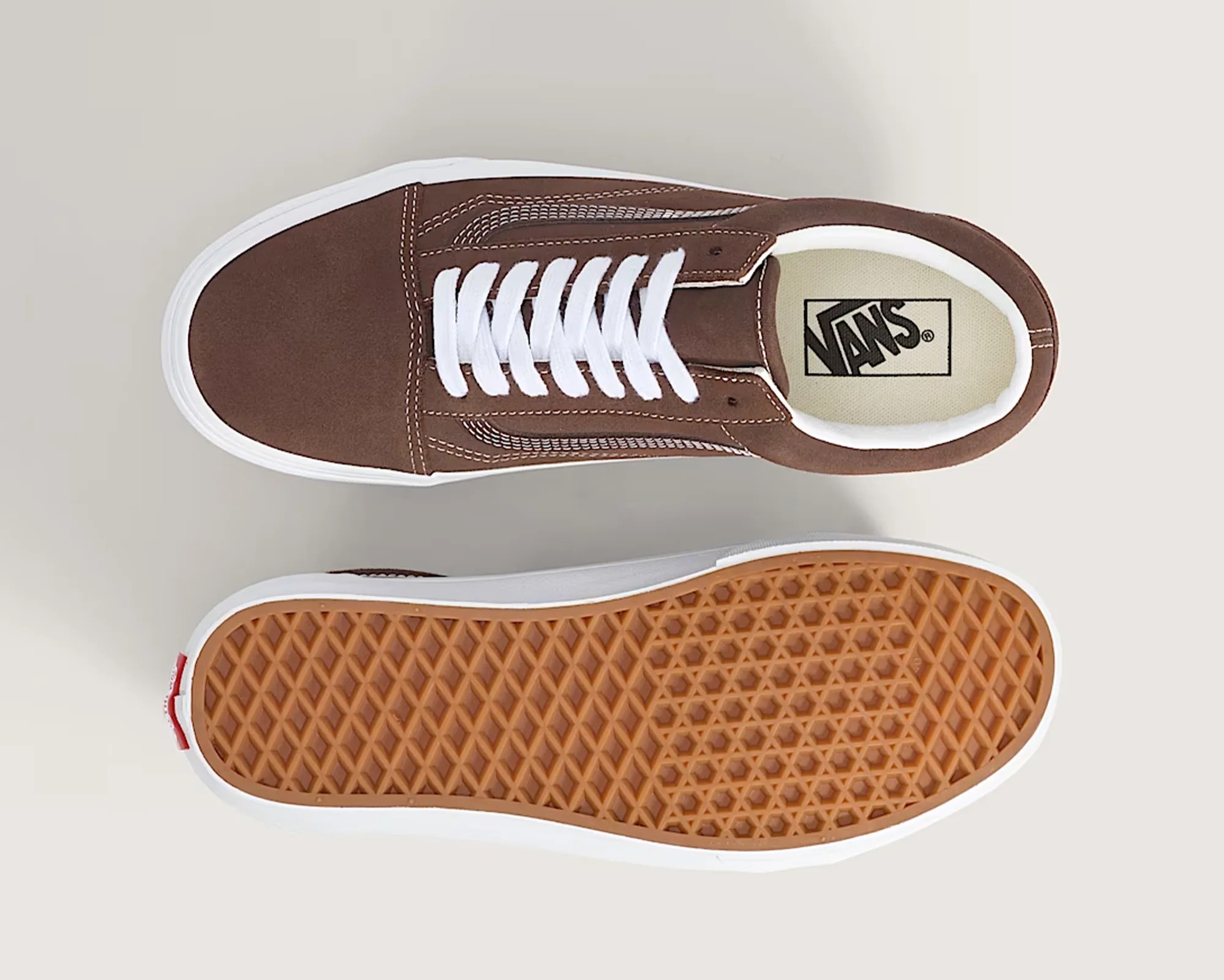 Pair of brown Vans sneakers with white laces and white rubber soles, one showing top view and the other sole.