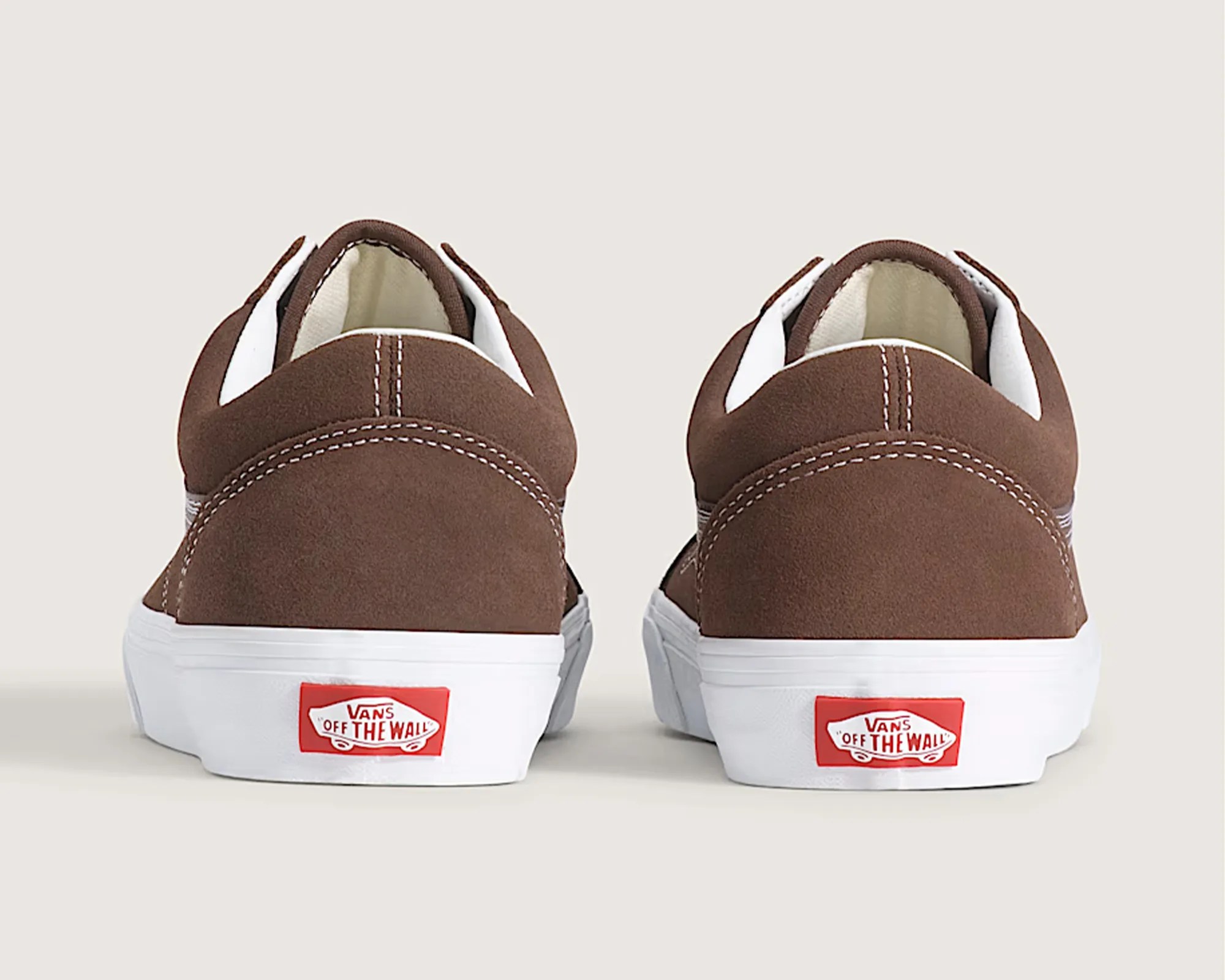 Pair of brown suede Vans sneakers shown from the back with white midsoles and red "Vans Off The Wall" logos.