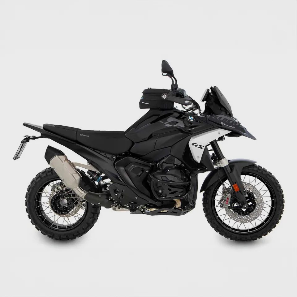 Black and white BMW GS adventure motorcycle with knobby tires and a small black tank bag.