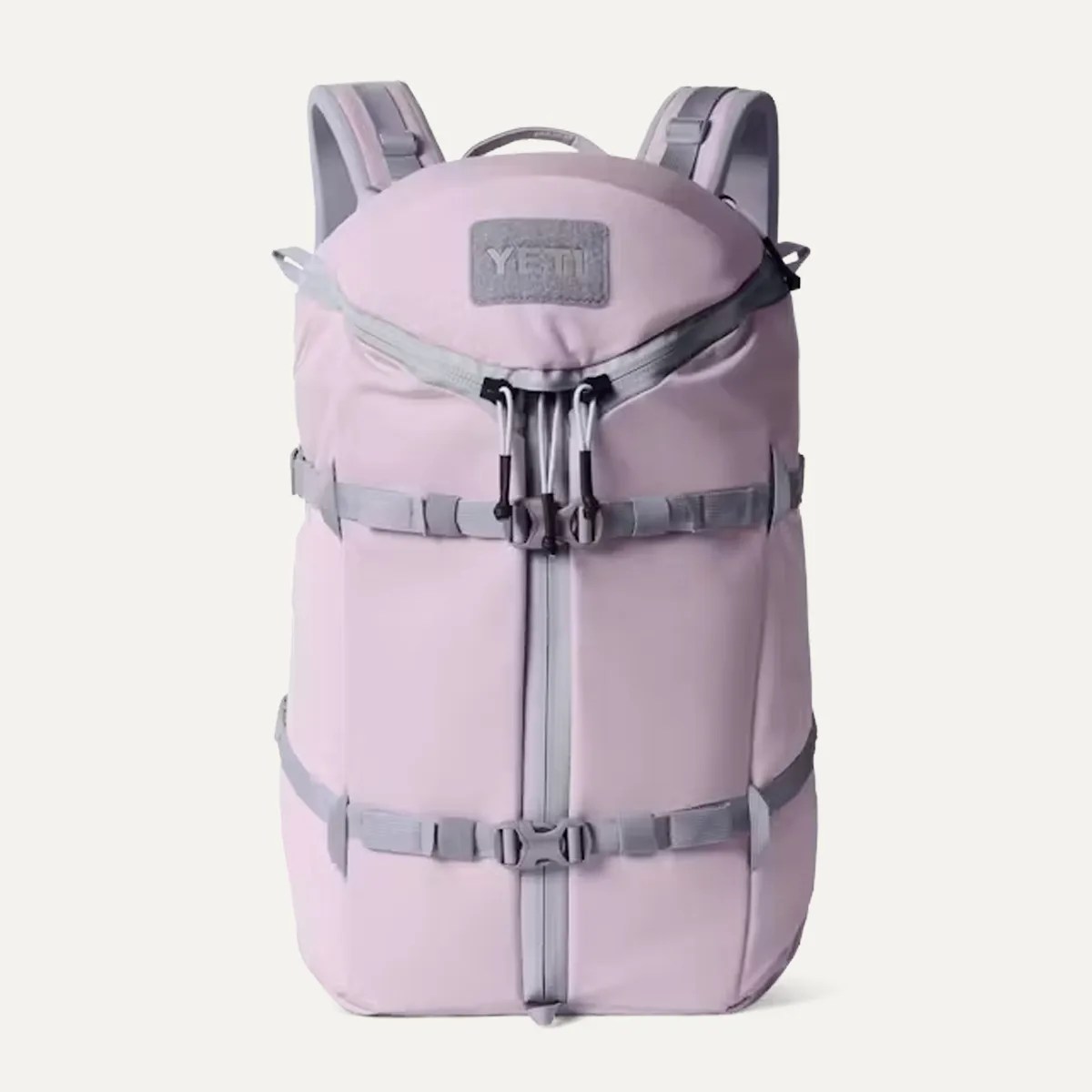 Light purple YETI backpack with gray straps and buckles, front zipper, and top handle.