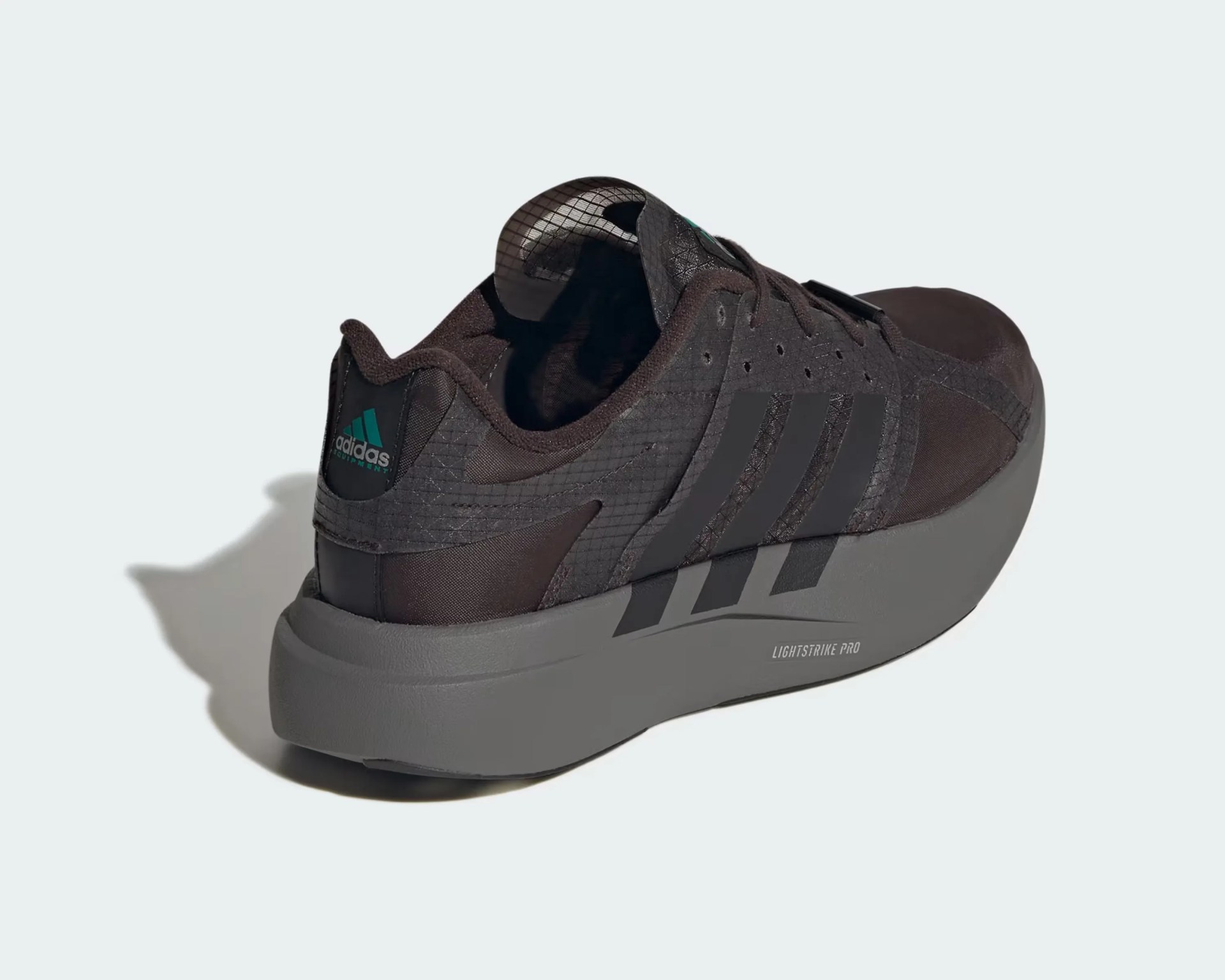 Dark brown Adidas sneaker with thick gray Lightstrike Pro sole, viewed from the back side.