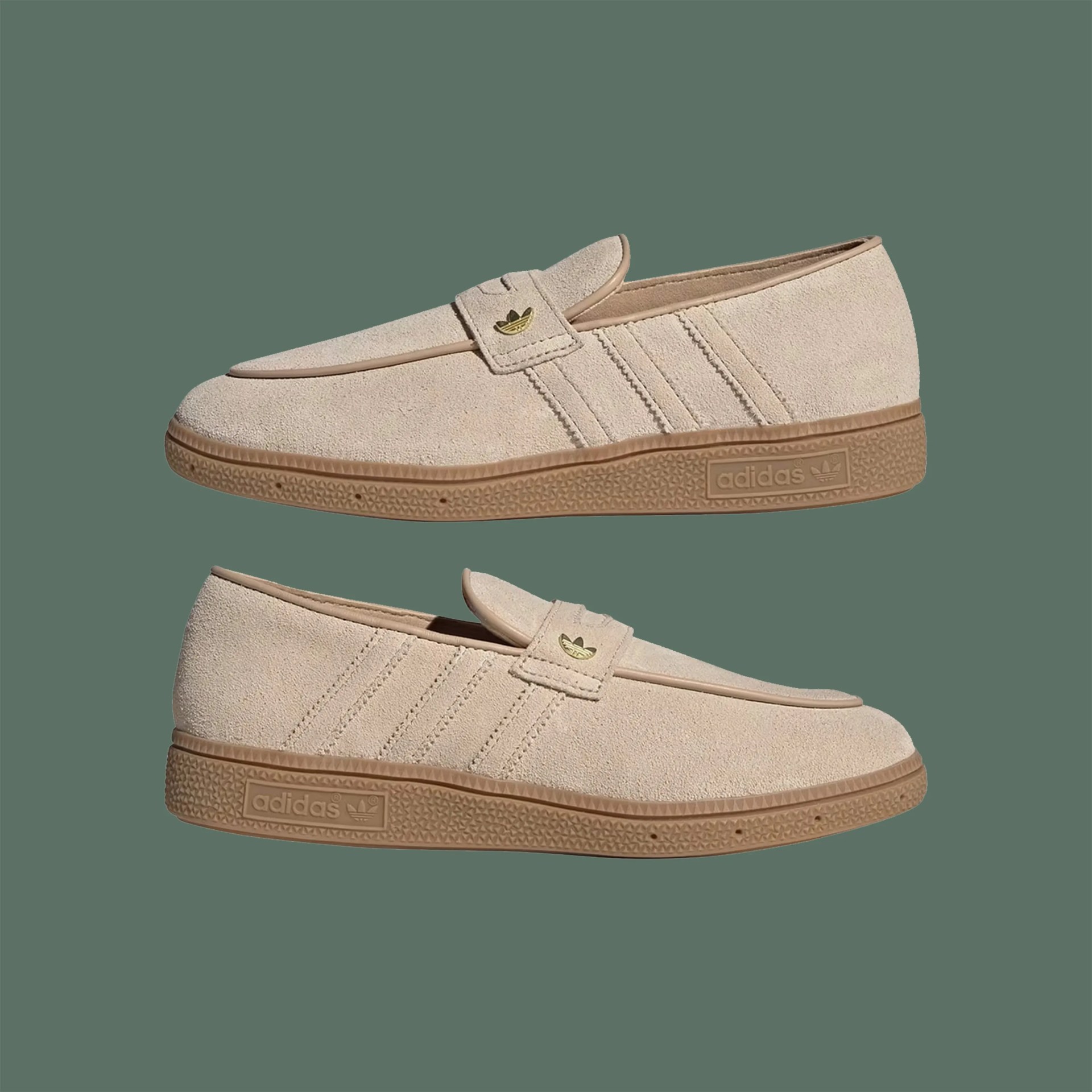 Pair of beige suede Adidas loafers with gum rubber soles and gold Adidas logo on strap.