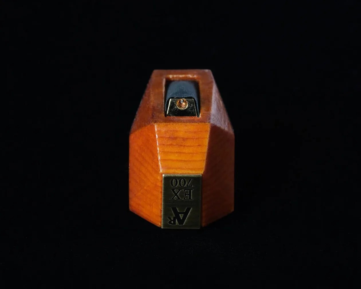 Wooden AR EX 700 guitar pickup with a black top and brass label on a black background.