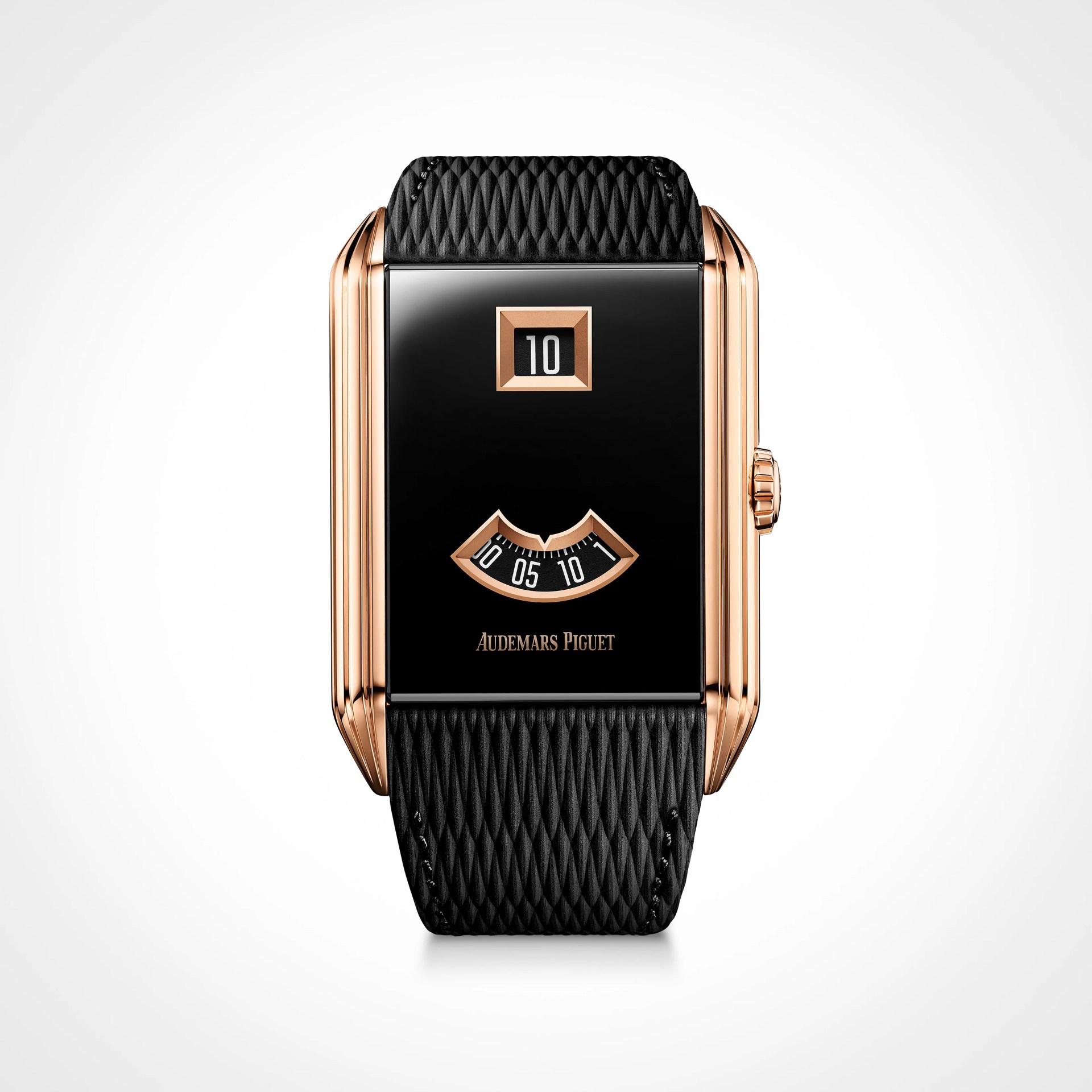 Rectangular rose gold Audemars Piguet watch with black textured strap and digital time display.