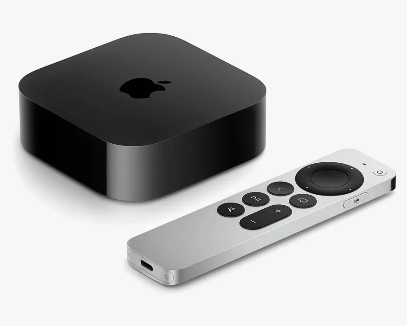 Black Apple TV streaming device with silver remote control featuring circular navigation and media buttons.