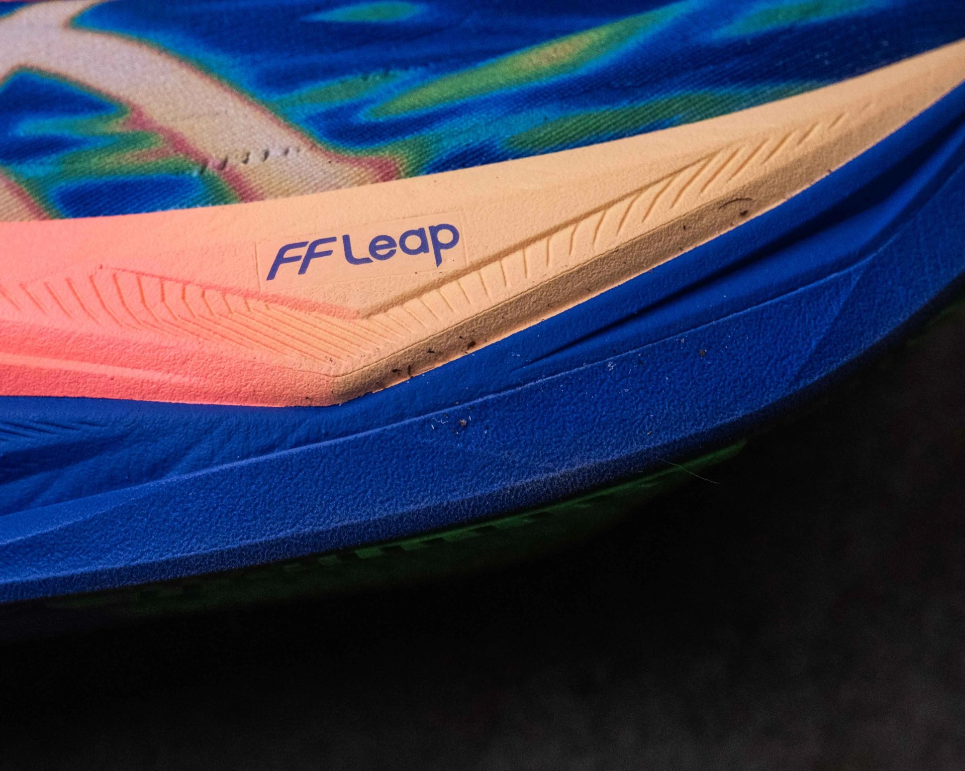 Close-up of a blue and pink shoe sole with "FF Leap" text on the pink section.
