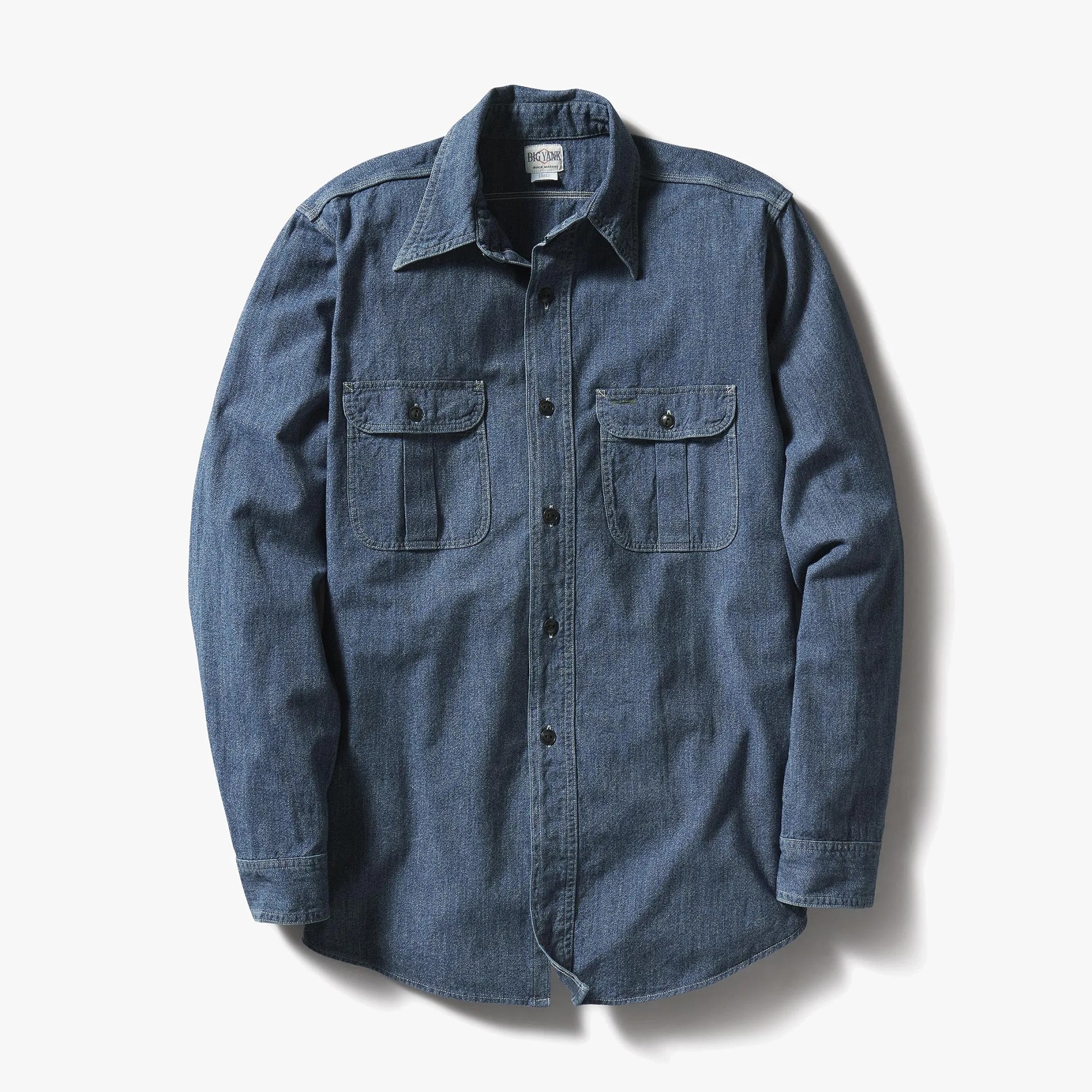 Blue denim long-sleeve button-up shirt with two front flap pockets.