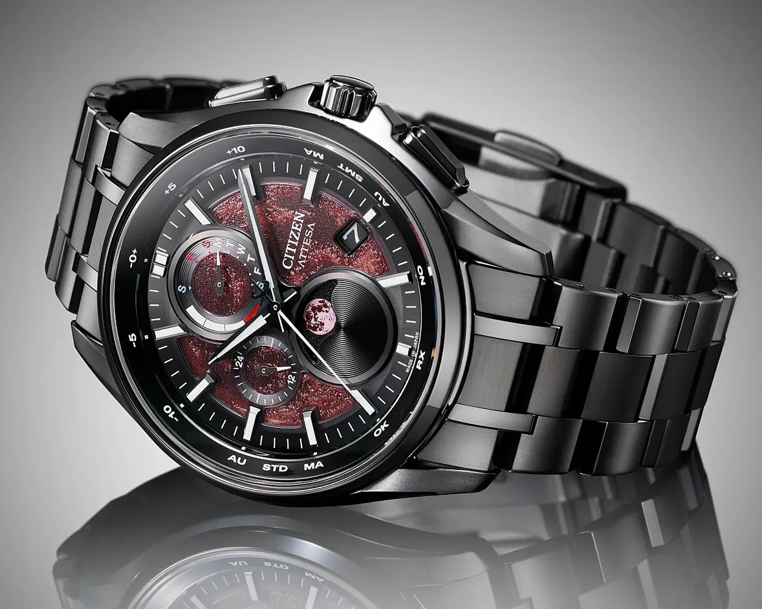 Black stainless steel Citizen Attesa wristwatch with a textured red dial and multiple subdials on a reflective surface.