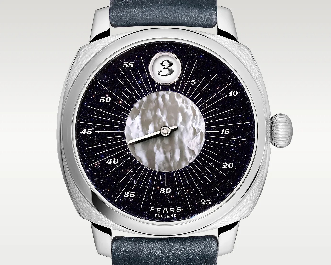 Silver wristwatch with a textured white center, dark starry dial, single hand, and black leather strap.