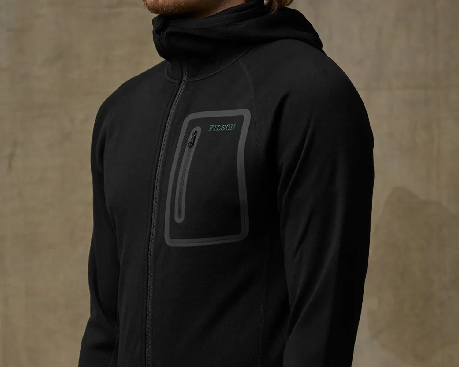 Black zip-up hoodie with a zippered chest pocket and "FILSON" logo on the left side.